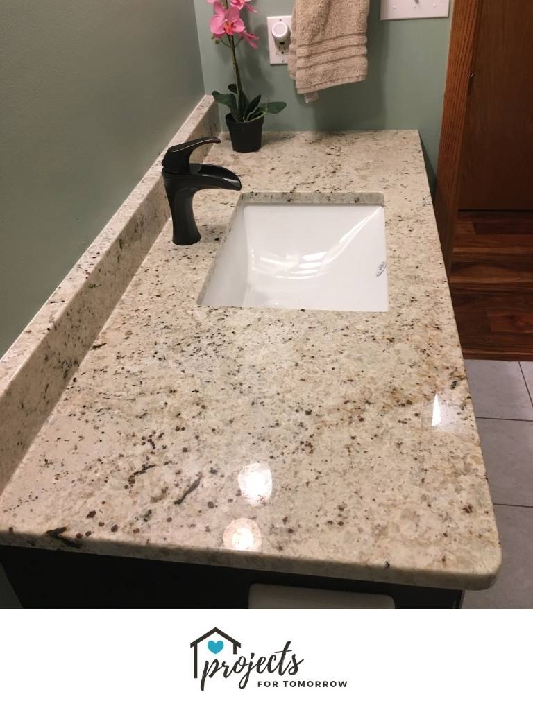 granite countertop, oil rubbed bronze faucet, white sink