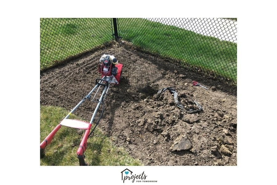 red gas powered tiller on patch of dirt