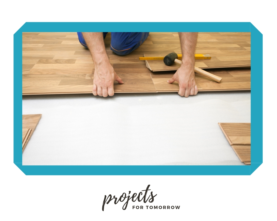 installing flooring during a kitchen renovation