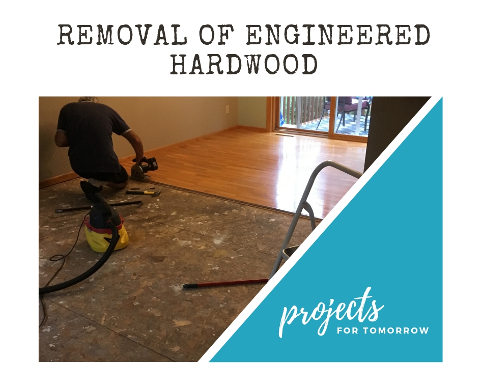 kitchen demolition flooring removal of engineered hardwood with a hand saw.